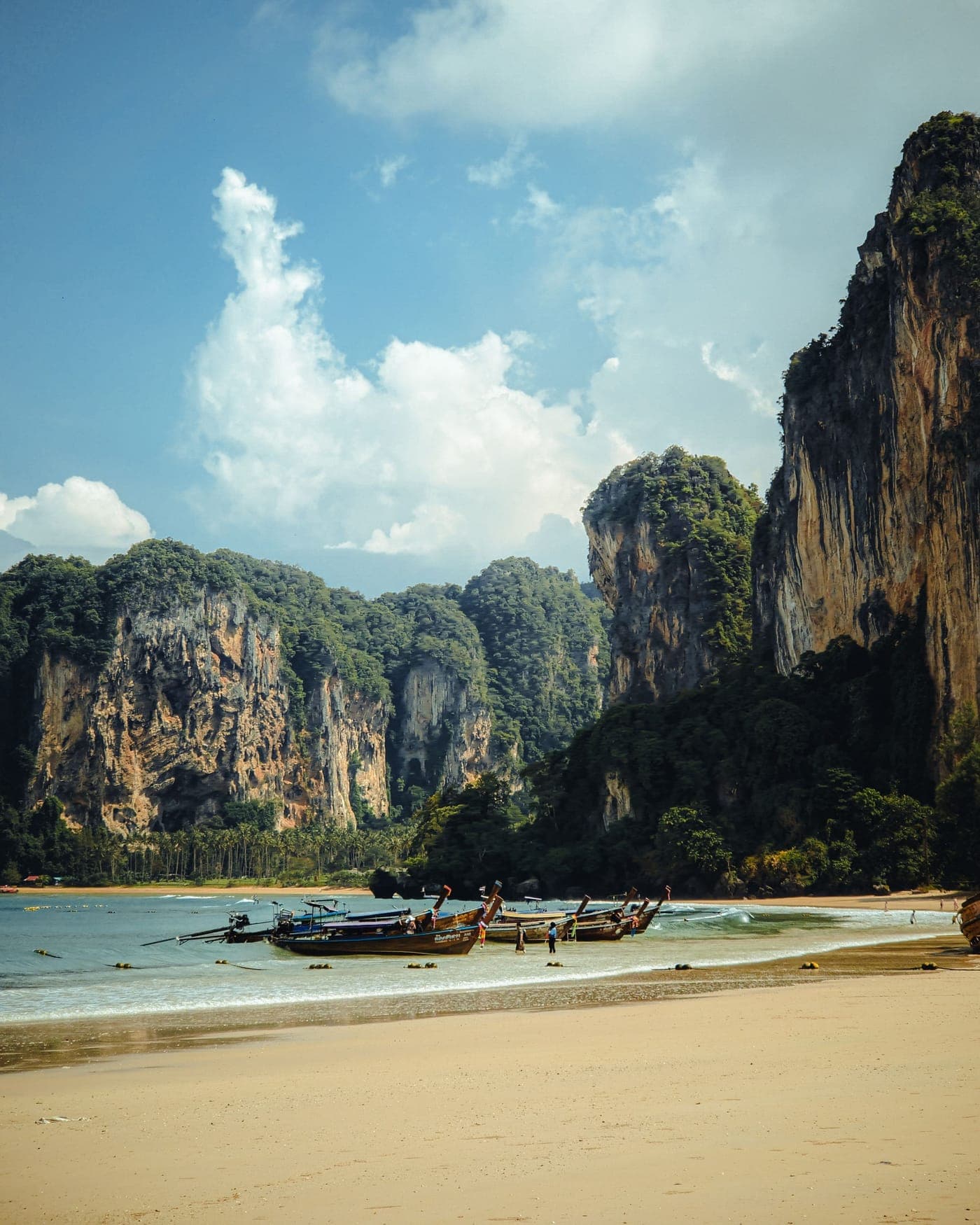 Longtail boats below the cliffs on the Krabi coast