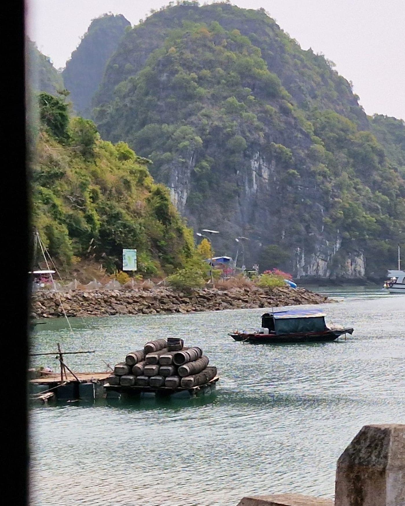 A boat among the limestone karsts of Ha Long Bay