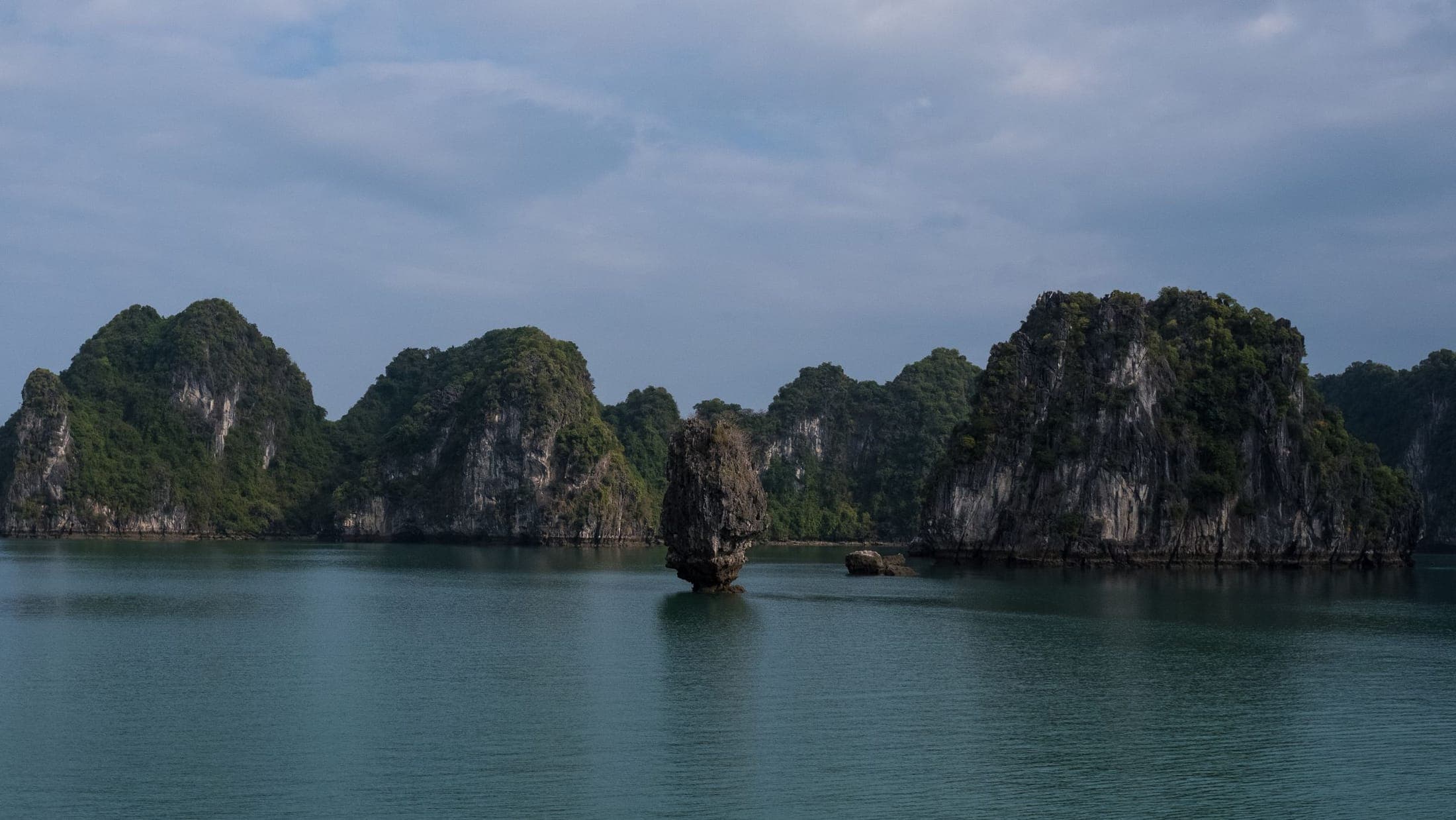 Limestone islands standing in the water of Ha Long Bay