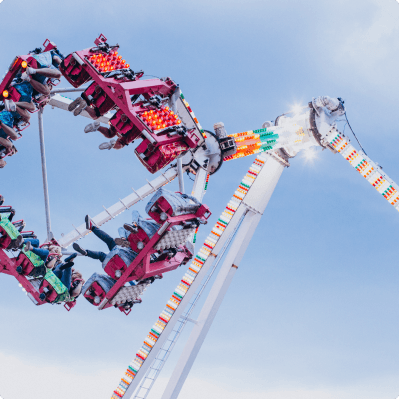A fairground thrill ride against a clear sky