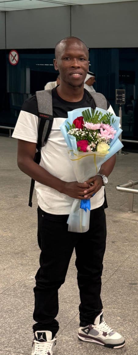 A traveller receiving flowers on arrival at Dubai airport