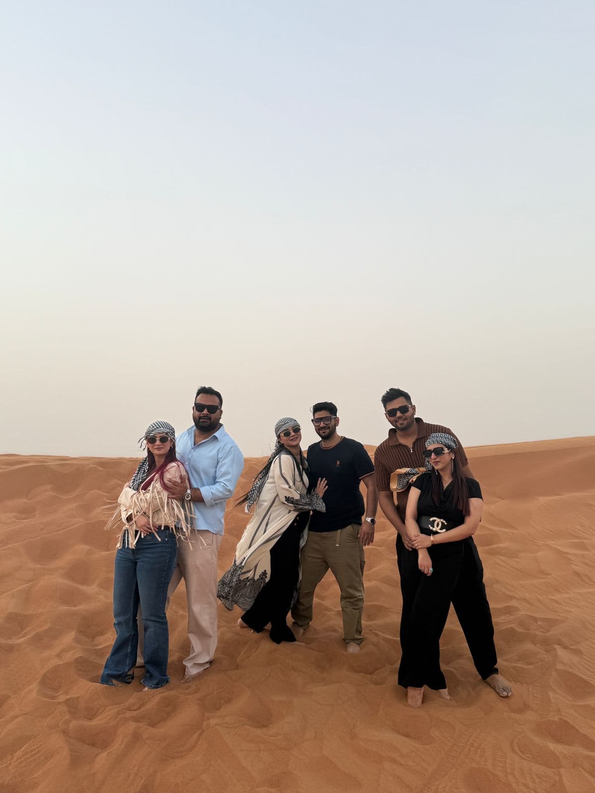Friends posing together during their desert safari